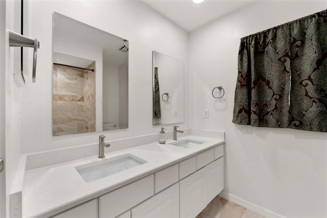 bathroom with vanity and a tile shower