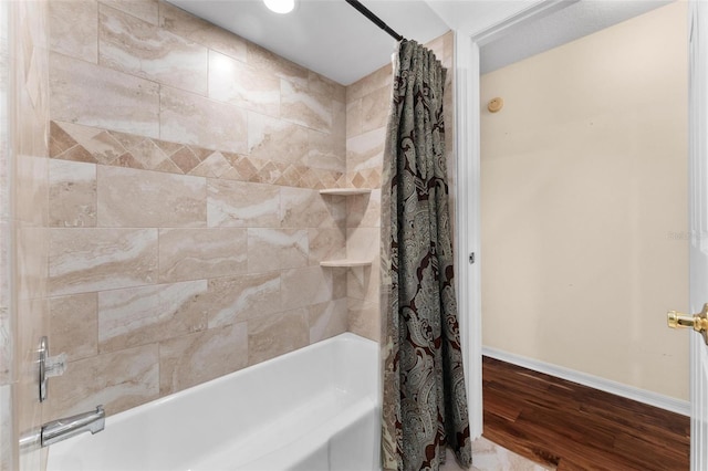 bathroom with shower / tub combo and hardwood / wood-style flooring