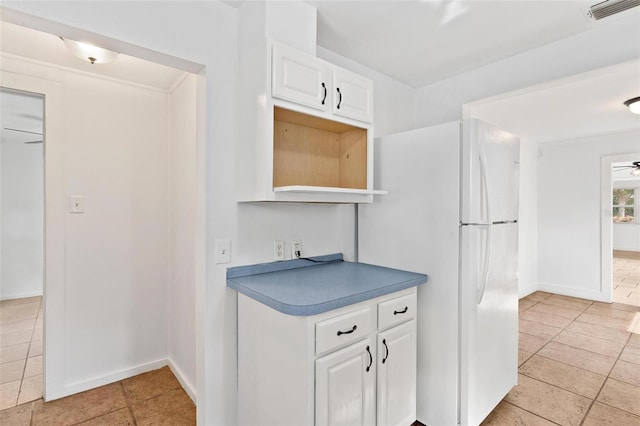 kitchen featuring white cabinetry, white fridge, light tile patterned floors, and ceiling fan