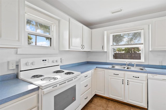 kitchen featuring white cabinetry, tile patterned flooring, sink, and white appliances