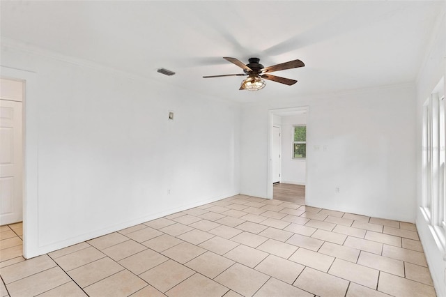 spare room featuring crown molding and ceiling fan