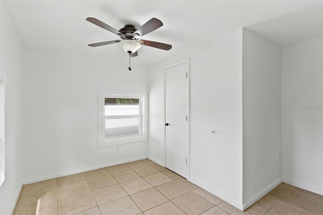 unfurnished room with light tile patterned flooring and ceiling fan