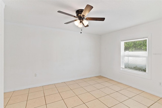 empty room with light tile patterned flooring and ceiling fan