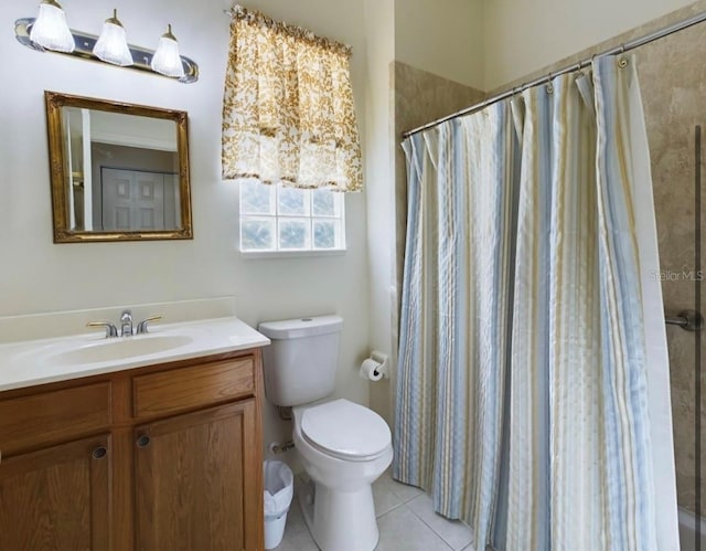 bathroom featuring vanity, a shower with shower curtain, tile patterned floors, and toilet