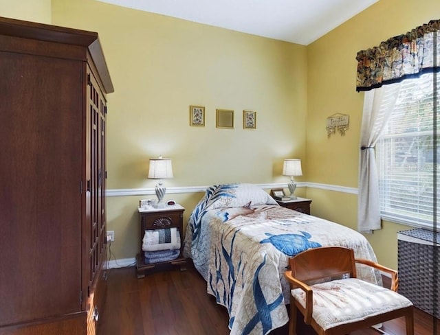 bedroom with dark hardwood / wood-style floors