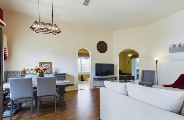 living room featuring dark hardwood / wood-style flooring and a notable chandelier