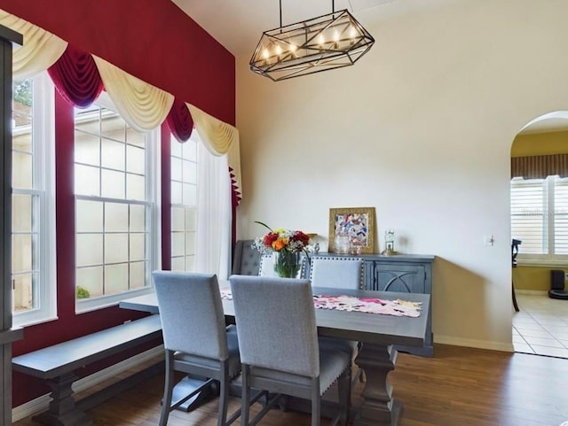 dining room with wood-type flooring and a notable chandelier