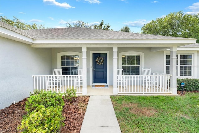 entrance to property featuring covered porch