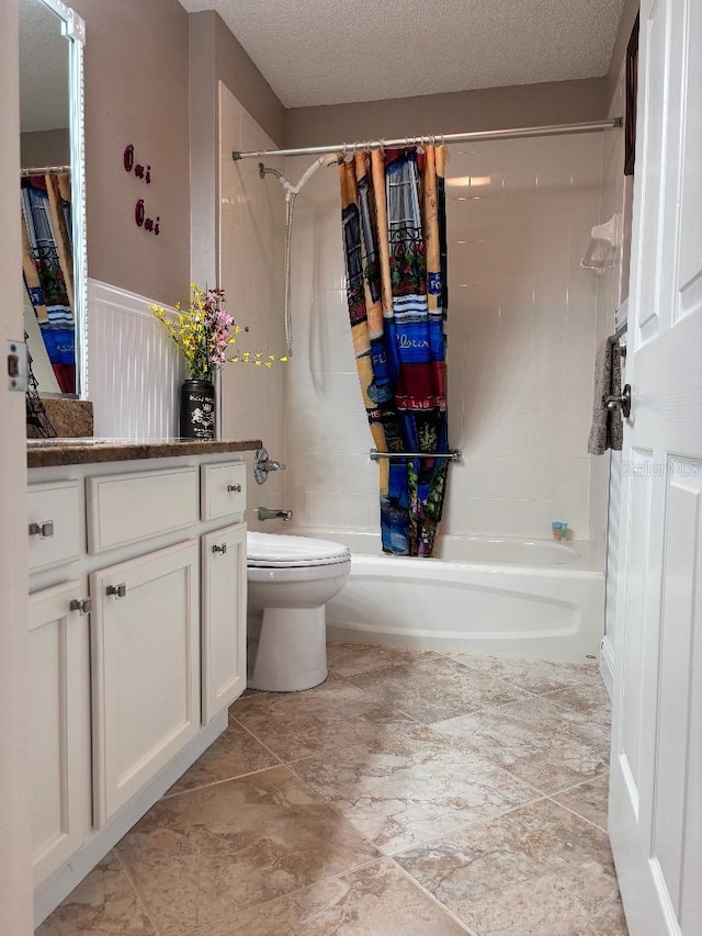 full bathroom with toilet, a textured ceiling, shower / bath combo, and vanity