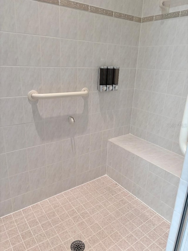 bathroom with a tile shower