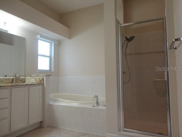 bathroom with vanity, shower with separate bathtub, and tile patterned floors