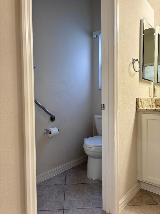 bathroom featuring vanity, toilet, and tile patterned floors