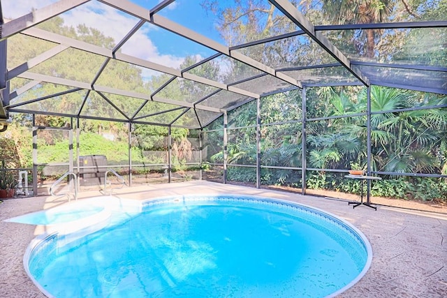 view of pool with a patio and a lanai