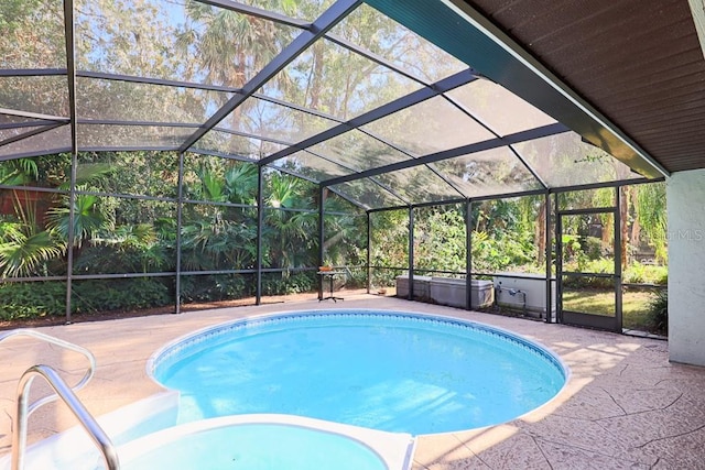 view of swimming pool with a lanai and a patio