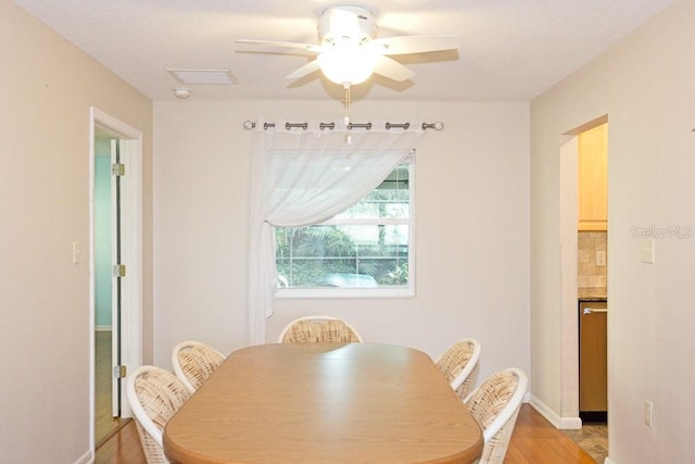 dining area with ceiling fan and light hardwood / wood-style flooring