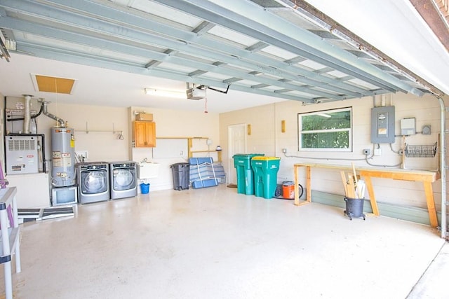 garage with washer and clothes dryer, a garage door opener, electric panel, and water heater