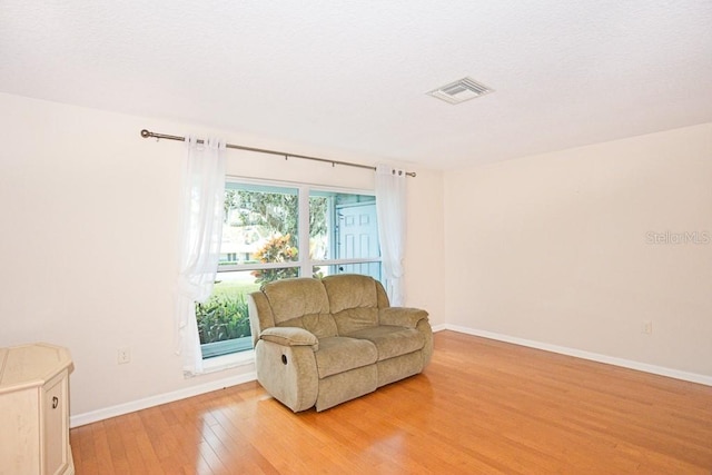 sitting room featuring wood-type flooring