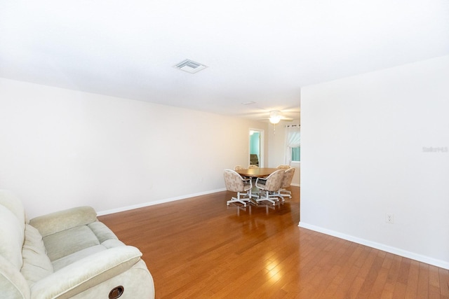 sitting room with wood-type flooring and ceiling fan