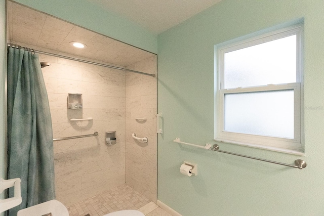 bathroom with walk in shower, a wealth of natural light, and toilet