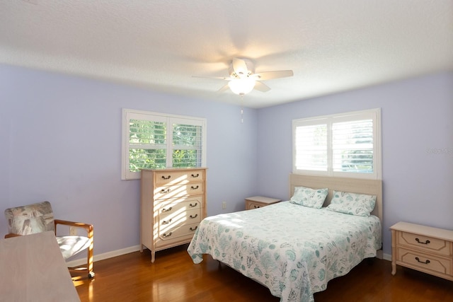 bedroom with ceiling fan and dark hardwood / wood-style floors