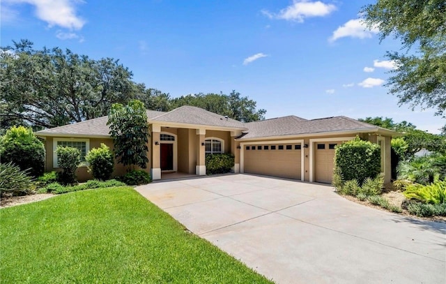 view of front of home featuring a garage and a front lawn