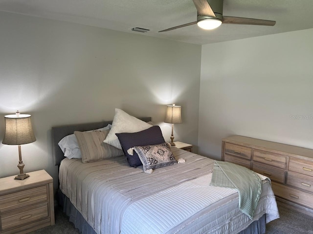 bedroom featuring dark colored carpet and ceiling fan