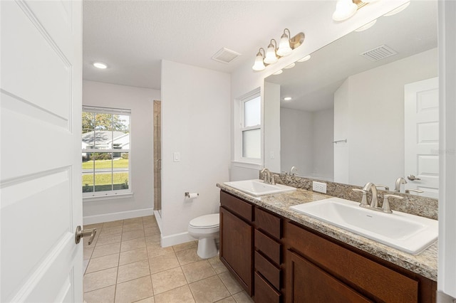 bathroom featuring a shower with door, a textured ceiling, toilet, vanity, and tile patterned flooring