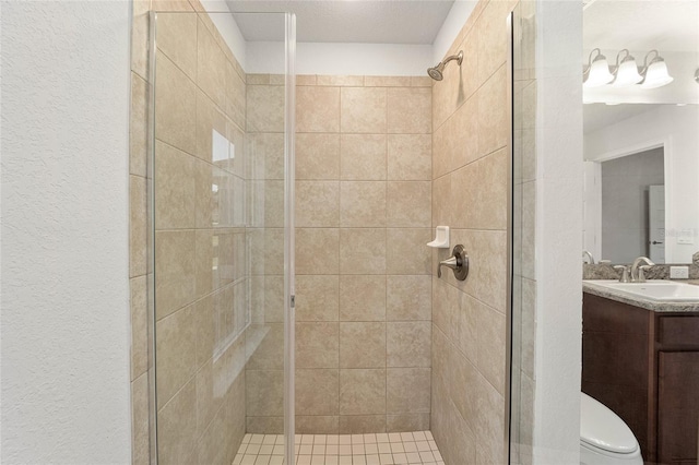 bathroom featuring vanity, a shower with shower door, and toilet