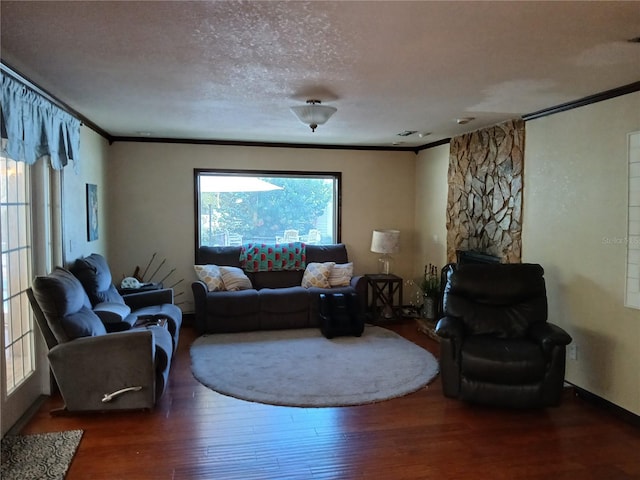 living room featuring a textured ceiling, dark hardwood / wood-style floors, and crown molding