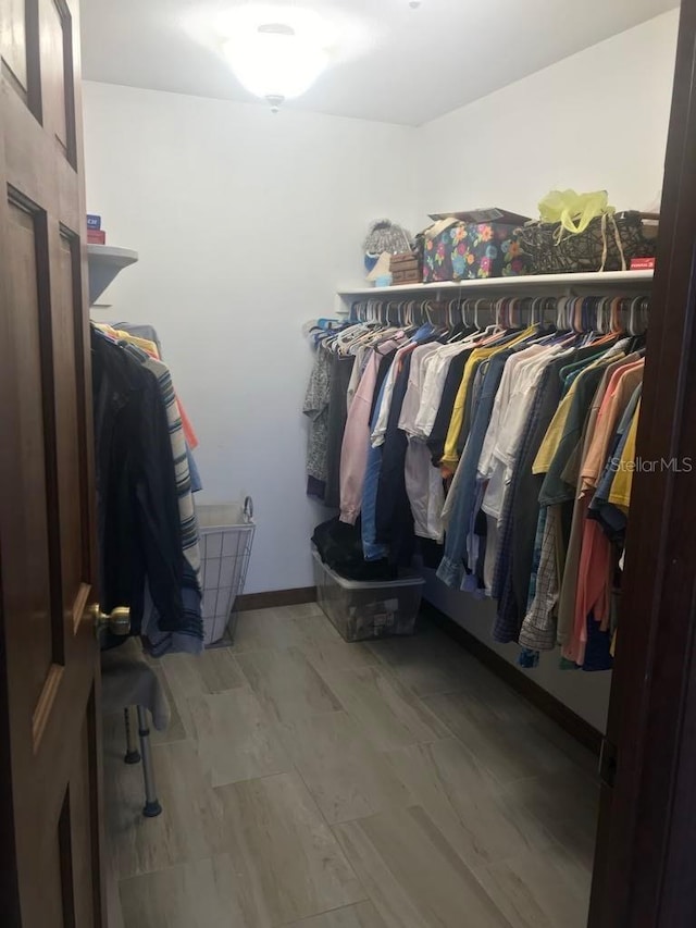 spacious closet featuring hardwood / wood-style flooring