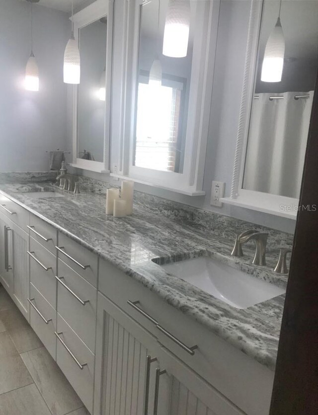 bathroom featuring tile patterned flooring and vanity