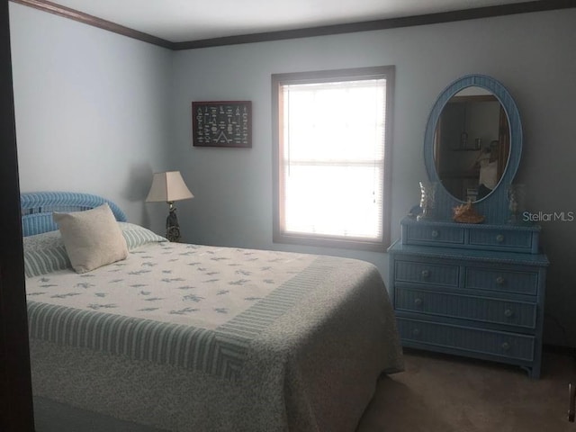 carpeted bedroom featuring crown molding and multiple windows