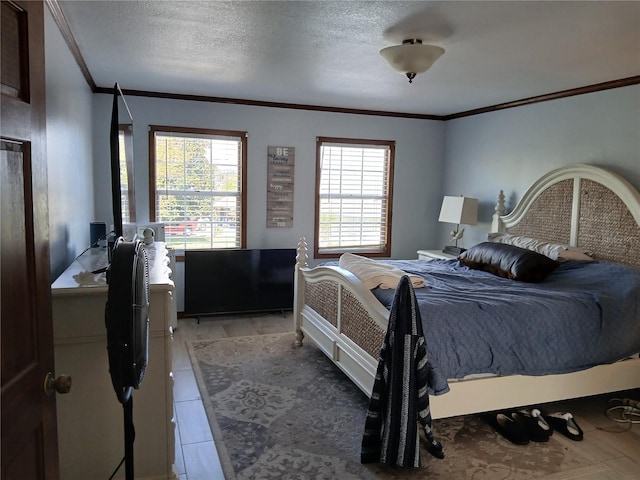 tiled bedroom featuring a textured ceiling and crown molding