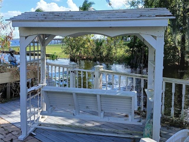 view of dock with a deck with water view