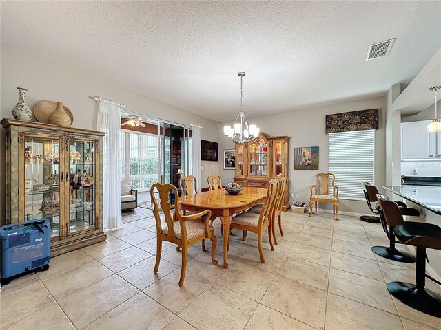 4088 Kingsley St, Clermont, FL 34711 - dining area with a chandelier, a textured ceiling, light tile patterned floors, and visible vents