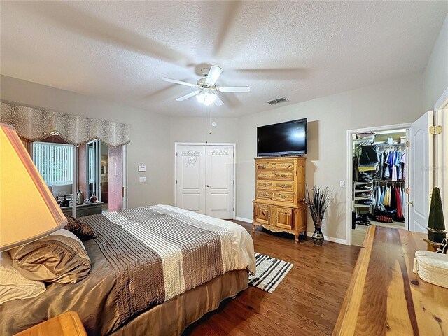 4088 Kingsley St, Clermont, FL 34711 - bedroom featuring a closet, a textured ceiling, visible vents, a walk in closet, and wood finished floors