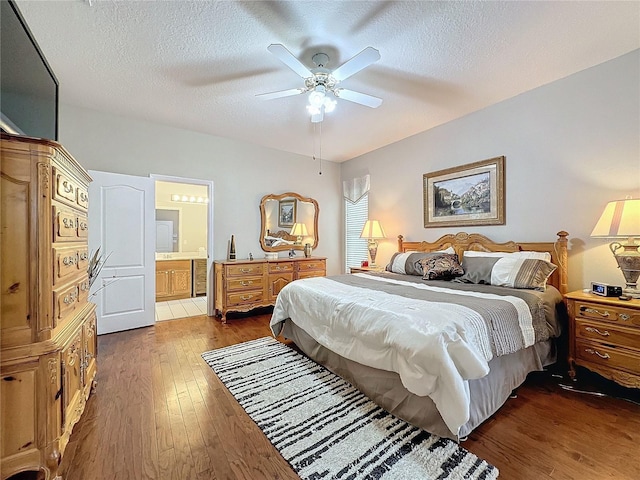 4088 Kingsley St, Clermont, FL 34711 - bedroom featuring a textured ceiling, ensuite bathroom, dark wood-style flooring, and a ceiling fan