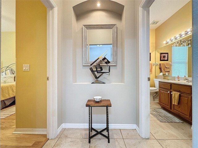 4088 Kingsley St, Clermont, FL 34711 - corridor with light tile patterned floors, baseboards, visible vents, and arched walkways