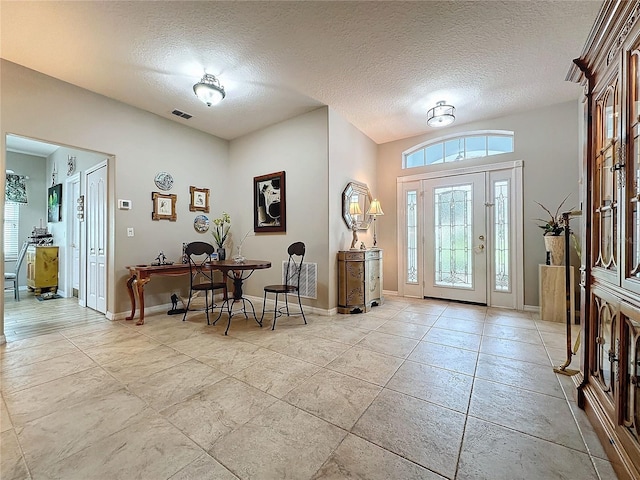 4088 Kingsley St, Clermont, FL 34711 - foyer entrance with baseboards, light tile patterned floors, visible vents, and a textured ceiling
