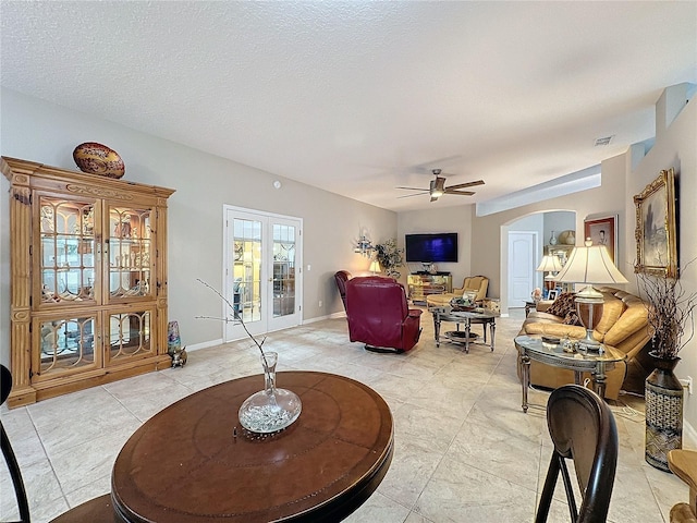 4088 Kingsley St, Clermont, FL 34711 - living area featuring light tile patterned floors, a ceiling fan, visible vents, baseboards, and arched walkways