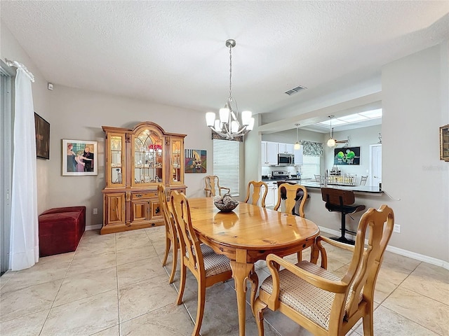 4088 Kingsley St, Clermont, FL 34711 - dining space with a textured ceiling, visible vents, a chandelier, light tile patterned floors, and baseboards
