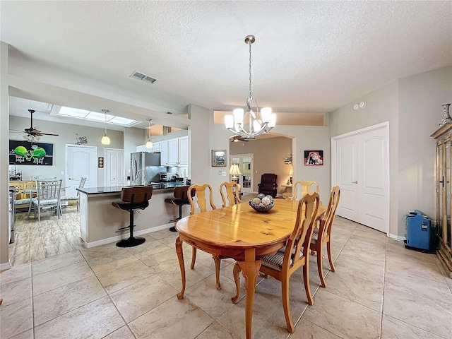 4088 Kingsley St, Clermont, FL 34711 - dining space featuring a textured ceiling, visible vents, baseboards, and ceiling fan with notable chandelier