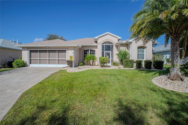 single story home featuring a garage and a front lawn