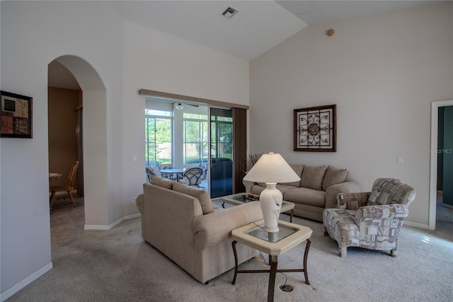 living room with light carpet and high vaulted ceiling