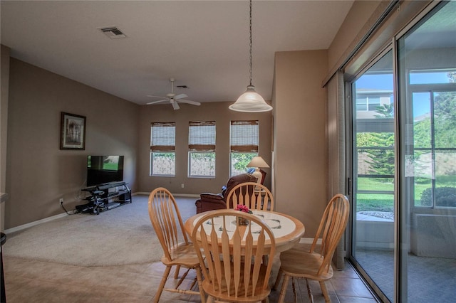 dining space with ceiling fan, carpet, and a wealth of natural light