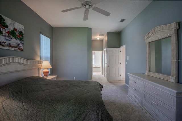 bedroom with a textured ceiling, light colored carpet, and ceiling fan