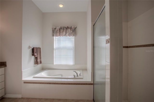 bathroom featuring vanity, shower with separate bathtub, and tile patterned flooring