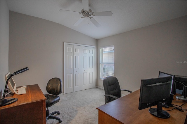 carpeted office space featuring lofted ceiling and ceiling fan