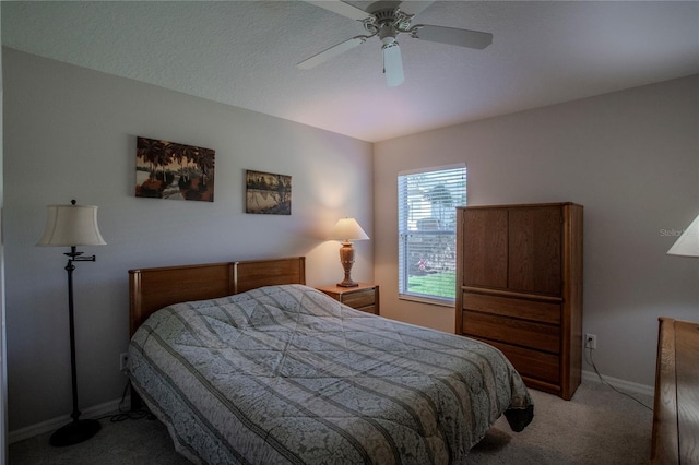 bedroom featuring a textured ceiling, carpet flooring, and ceiling fan