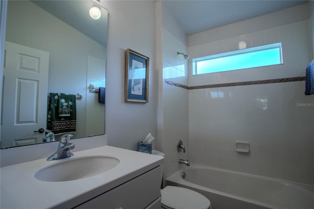 full bathroom with vanity, toilet, vaulted ceiling, and tiled shower / bath